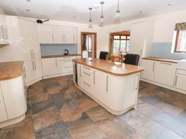 A kitchen with cabinets and a countertop at Ty-Gan Dderwen in Llanelli