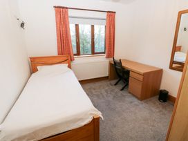 A bedroom with a bed and desk at Ty-Gan Dderwen Llanelli