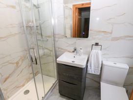 A bathroom with a shower, sink and toilet at Ty-Gan Dderwen in Llanelli