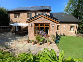 A house with a garden and patio at Ty-Gan Dderwen in Llangennech