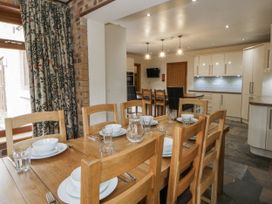A dining room with a table set for dinner at Ty-Gan Dderwen in Llangennech