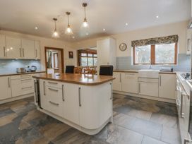 A kitchen with an island and sink at Ty-Gan Dderwen in Llangennech