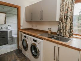 A laundry room with washing machine and dryer at Ty-Gan Dderwen Llangennech