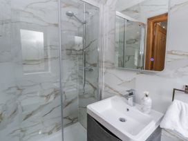 A bathroom with a shower and sink at Ty-Gan Dderwen in Llangennech