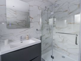 A bathroom with a shower and sink at Ty-Gan Dderwen in Llangennech