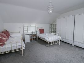 A bedroom with two beds and a desk at Ty-Gan Dderwen in Llangennech