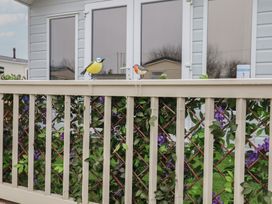 Decorative birds on a railing with foliage at Offspray Court 1 Scratby