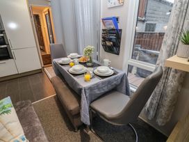 A dining room with a table set for breakfast at Offspray Court 1 Scratby