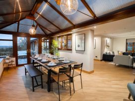 A dining area with a table set for dinner at Kestrel Cottage, Llangaffo