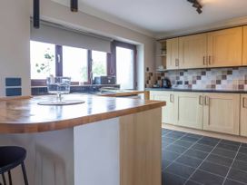 A kitchen with cabinets and a countertop at Kestrel Cottage Llangaffo