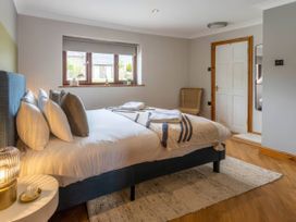 A bedroom with a bed and a bedside table at Kestrel Cottage in Llangaffo