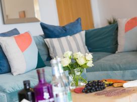 A living room with a sofa and decorative items at Mid Air in St. Ives