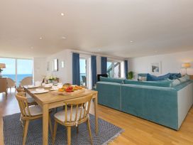 A living room with a dining area and seating at Mid Air in St. Ives