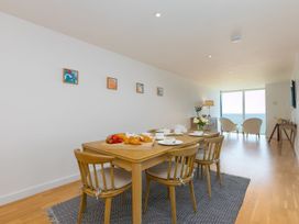 A dining room with a table set for tea and pastries at Mid Air in St. Ives
