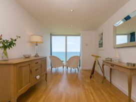 A living room with a telescope and chairs at Mid Air in St. Ives