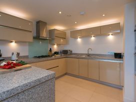 A kitchen with a stove and microwave at Mid Air in St. Ives