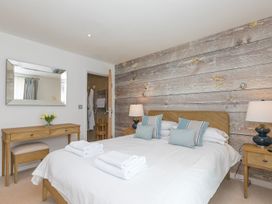 A bedroom with a bed and a mirror at Mid Air St. Ives