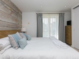 A bedroom with a bed and curtains at Mid Air in St. Ives