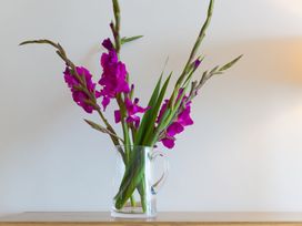 A vase with flowers on a table at Mid Air in St. Ives