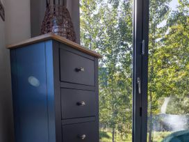 A drawer unit next to a window with trees outside at Isca Lodge in Wombleton
