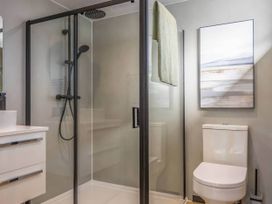 A bathroom with a shower, toilet, and sink at Isca Lodge in Wombleton