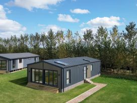 A house with a garden and pathway at Rye Lodge in Wombleton