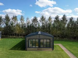 A house with large windows and a pathway at Rye Lodge in Wombleton