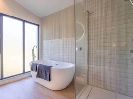 A bathroom featuring a bathtub and shower at Rye Lodge in Wombleton