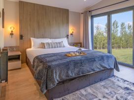 A bedroom with a bed and a window at Rye Lodge Wombleton