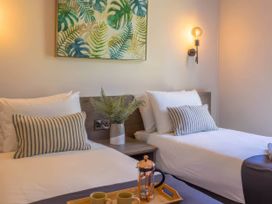 A bedroom with two beds and a plant at Rye Lodge Wombleton