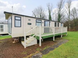 An outdoor view of a caravan with steps and a deck at Caravan number 77