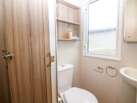A bathroom with a toilet and sink at Caravan number 77