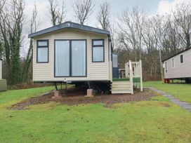 A caravan with steps and grass at Caravan number 77