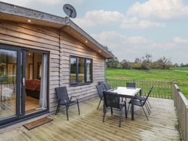 A deck with a table and chairs at Oak Lodge Admaston near Abbots Bromley