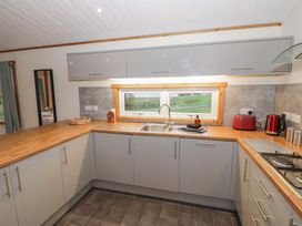 A kitchen with a sink and appliances at Oak Lodge in Admaston near Abbots Bromley