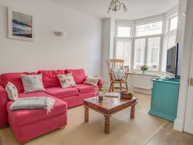 A living room with a sofa and a coffee table at Seahorse Cottage in Weymouth