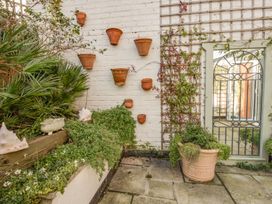 A garden with wall planters and potted plants at Seahorse Cottage in Weymouth