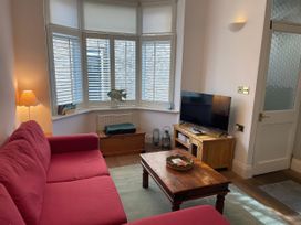 A living room with a sofa and television at Seahorse Cottage in Weymouth