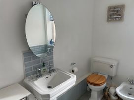 A bathroom with a sink and toilet at Seahorse Cottage in Weymouth