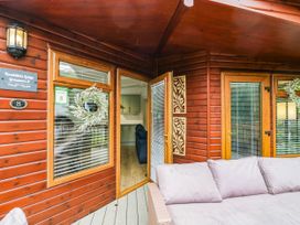 An outdoor area with a sofa and a wreath at Terabithia Lodge in Troutbeck