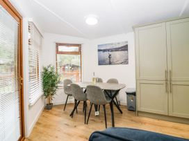 A dining room with a table and chairs at Terabitha Lodge in Troutbeck