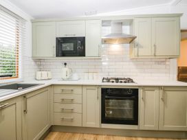 A kitchen with modern appliances at Terabitha Lodge in Troutbeck