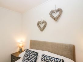 A bedroom with a bed and decorative hearts at Terabitha Lodge in Troutbeck