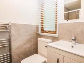 A bathroom with a toilet and sink at Terabitha Lodge Troutbeck
