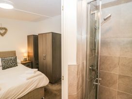 A bedroom with a bed and wardrobe at Terabitha Lodge in Troutbeck