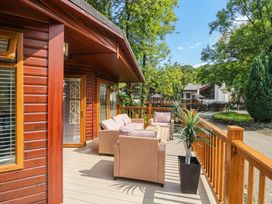 An outdoor seating area with sofa and chairs at Terabitha Lodge in Troutbeck