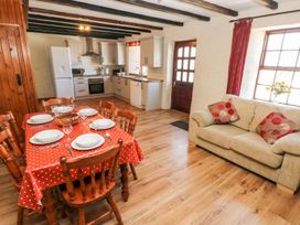 A kitchen with dining table and chairs at Ty Fferm in Newport