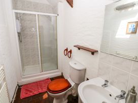 A bathroom with a shower, toilet, and sink at Ty Fferm in Newport