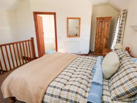 A bedroom with a bed and wardrobe at Ty Fferm in Newport