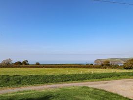 A view of the sea and hills with fields at Ty Felin in Newport